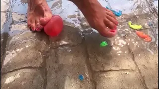 Foot fetish crushing water balloons with heels