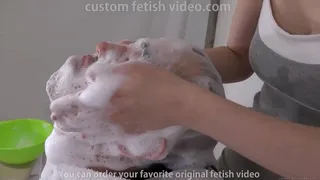Woman washing man's face with laughter