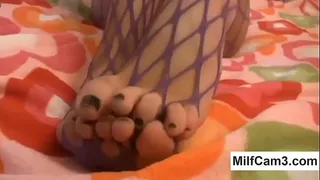 Chick in fishnets toying her pussy hole