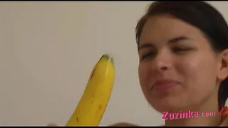 How-to: Young brunette girl teaches using a banana