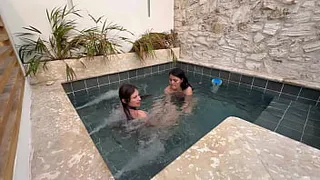 Two hot lesbians masturbate in a public pool, afraid of getting caught.