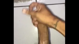 Young man splashing yummy milk