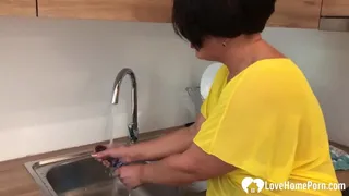 Horny MILF masturbating in kitchen