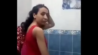 An Egyptian woman in the bathroom performing