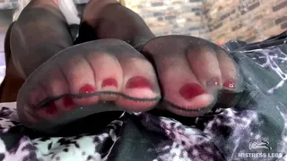 Black nylons feet into your face