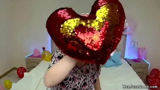 Cute redhead amateur babe NicolPot in colorful blouse chatting with her fans and playing with red heart shaped pillow in front of her webcam