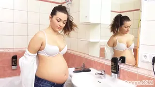 Missy pauses to admire her pregnant body in the bathroom mirror!