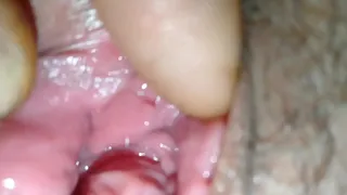 Spreading her pussy and using her fingers to play with her clit before stuffing her pussy with his cock.