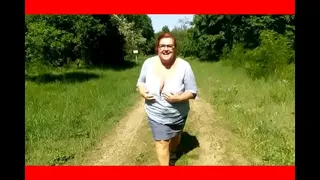 Kathy pulls out her huge tits in nature