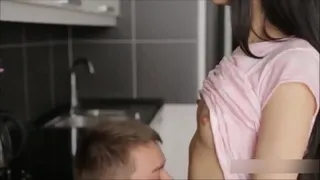 A intimate couple have sensual sex in kitchen.