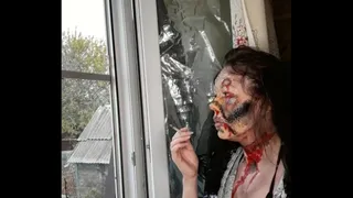 smoking woman with makeup by the window