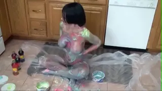 Brunette Melissa Swallows with big tits exhibits her body as colorful art on kitchen floor