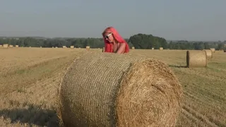Bikini, hay rolls and field