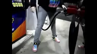 desperate girl wetting pee jeans while pumping gas