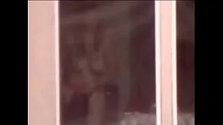 Spying on an exhibitionist from the building across the street
