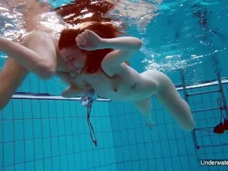 Lesbians swimming passionately