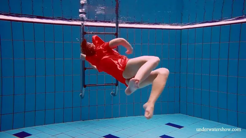 Red-Dressed Vixen Plunges into Pool